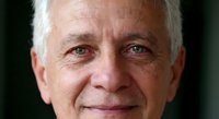 Senior Caucasian businessman with gray hair and warm smile showing confidence and experience in corporate leadership and professional success.