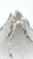 Textured white powder mountain formation isolated on neutral background, suitable for cosmetics, skincare, design projects, and creative compositions.