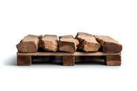 Milk chocolate pieces arranged on miniature wooden pallet against white background, isolated product photography for confectionery and sweet food marketing.