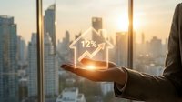 Business professional holding holographic house icon with 12% interest rate display against urban skyline at sunset for real estate investment concepts.