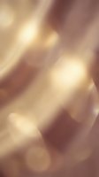 Abstract golden bokeh lights background with warm glowing circles and soft blur effect for elegant design projects and luxury presentations.