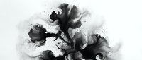 Abstract black ink blot spreading on white paper creating organic flowing shapes with splatter effects for artistic design projects.