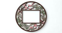 Ornate circular frame with cherry blossom flowers and leaves isolated on white background for decorative design projects and vintage artwork.