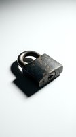 Antique padlock with weathered metal finish and arched shackle isolated on white background, suitable for security, vintage, and industrial design projects.
