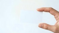 Male hand with light skin tone holding or measuring small invisible object against white background, suitable for product mockups, size comparison, and commercial advertising.