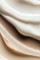 Luxurious swirls of cream and caramel blend in smooth waves creating an elegant abstract background with soft sparkles and gentle flowing curves.
