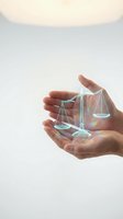 Hands holding glowing holographic scales of justice against neutral background, symbolizing law, ethics, balance, fairness, legal services, compliance, and corporate responsibility for business presentations.