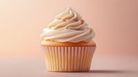Vanilla cupcake with swirled buttercream frosting on soft pink background. Elegant pastry photography showcasing delicate texture and professional bakery presentation.