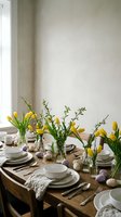Easter dining table decorated with yellow tulips in glass vases, white dinnerware, and colorful eggs for spring holiday celebration.