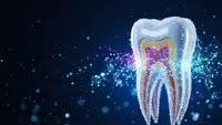 Glowing tooth anatomy with sparkling particles on dark blue background for dental care and oral health concepts in medical presentations.