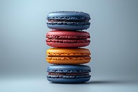 Colorful French macarons stacked in vibrant blue, red, orange and purple shades against neutral background, showcasing delicate meringue texture and creamy filling.