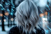 Back view of young woman with silver wavy hair against blurred city lights and rain. Moody atmospheric night photography with bokeh effects and blue tones.
