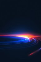 Dynamic light trails curve along dark background creating futuristic motion effect with vibrant blue, red and orange streaks glowing against black space.