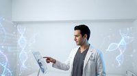Young male scientist in white lab coat analyzing DNA data on tablet with holographic double helix projections in modern laboratory for medical research.