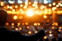 Silhouette of man reaching toward glowing sunset with magical bokeh lights creating dreamy atmosphere, back view of person experiencing spiritual moment at dusk.