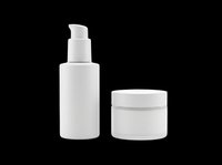 Blank white cosmetic bottles with pump dispenser and jar isolated on transparent background, ready for skincare, lotion, serum packaging design, labels, branding mockups, and product presentations.