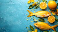 Fresh raw golden fish with citrus oranges, green leaves and spices on textured blue background with copy space for seafood restaurant menu.
