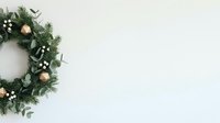 Festive evergreen wreath with gold ornaments, white berries and greenery on neutral background for holiday decorating and seasonal celebrations.