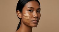 Young mixed-race woman with foundation swatches on face demonstrating makeup color matching for cosmetic testing and beauty product selection.