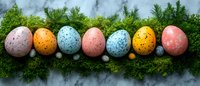 Colorful speckled Easter eggs arranged in row on fresh green moss against marble background, festive spring holiday decoration in pastel colors.