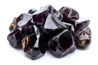 Collection of raw smoky quartz crystals and amethyst gemstones on white background isolated for jewelry design and mineral specimen display.