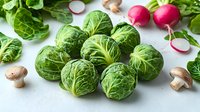 Fresh brussels sprouts with mushrooms and radishes on light background, raw organic vegetables for healthy cooking, clean eating concept.