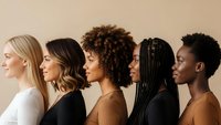 Diverse group of women in profile showing different hair textures and ethnicities representing beauty inclusivity and multicultural unity.