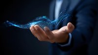 Professional businessman in dark suit holding glowing blue digital wave pattern floating above palm, representing digital transformation and innovation.