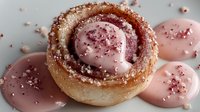 Cinnamon roll with pink icing and sprinkles on white background, sweet pastry dessert for bakery menu and food photography projects.