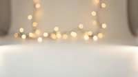 Soft bokeh lights creating warm ambient glow on blurred background for holiday decorations, wedding events, and romantic atmosphere design projects.