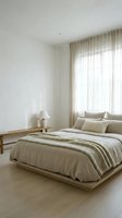 Serene minimalist bedroom with natural light streaming through sheer curtains, featuring a low wooden platform bed with neutral bedding, simple nightstand with lamp, and clean white walls for interior design projects.