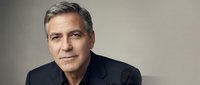 Middle-aged man with gray hair and light skin tone wearing dark blazer against neutral background for corporate and professional use.