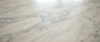 Elegant white marble surface with natural gray veining patterns creating luxurious texture for interior design and architectural backgrounds.