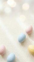 Pastel colored Easter eggs with delicate floral patterns on soft cream background with warm bokeh lights creating festive spring holiday atmosphere.
