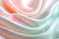 Soft pastel waves of pink, peach and mint green create gentle flowing curves in abstract macro photography, evoking tranquil and dreamy atmosphere.