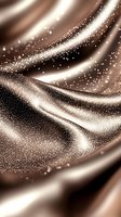 Shimmering waves of brown and beige silk fabric with sparkling glitter effect create luxurious flowing abstract background for elegant design projects.
