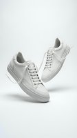 Pair of white leather low-top sneakers floating on light background, minimalist casual footwear for fashion, retail, and lifestyle projects.