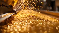 Golden glitter particles falling and creating magical bokeh effect on blurred background, sparkling festive atmosphere with warm lighting and soft focus.