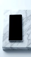 Smartphone with blank black screen on white marble surface, ready for app display or mockup design projects.