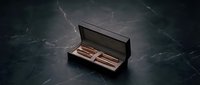 Luxury chocolate bars in elegant black gift box on dark marble surface for premium confectionery branding and gourmet food marketing campaigns.