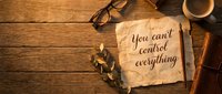 You can't control everything written on aged parchment paper on rustic wooden desk with glasses, coffee cup, and dried leaves.