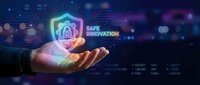 Safe innovation concept with glowing neon shield and padlock icon held in hand against digital circuit board background. Cybersecurity and data protection.