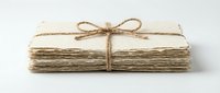 Stack of aged paper sheets tied with twine bow, suitable for packaging, gift wrapping, craft projects, and rustic design presentations.