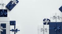 Wrapped gift boxes with blue and silver ribbons arranged on white background, suitable for holiday, Christmas, and celebration design projects.