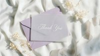 Elegant lavender thank you card with matching envelope on soft white silk fabric, surrounded by delicate dried flowers for wedding stationery.