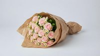 Pink roses bouquet wrapped in brown kraft paper on white background, romantic flower arrangement for gifts, weddings, anniversaries and special occasions.