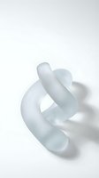 Translucent glass sculpture with flowing organic curves creating abstract twisted form on white background for modern interior design.