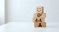 Wooden blocks with emotional faces stacked on white surface showing progression from sad to happy expressions for mental health and wellness concepts.