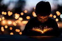 Young Asian boy reading magical glowing book at dusk with bokeh lights in background creating dreamy atmosphere for education and imagination concepts.