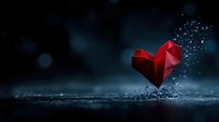 Red geometric heart shape shattering into particles against dark moody background with water droplets and bokeh effects, dramatic lighting creates emotional atmosphere.